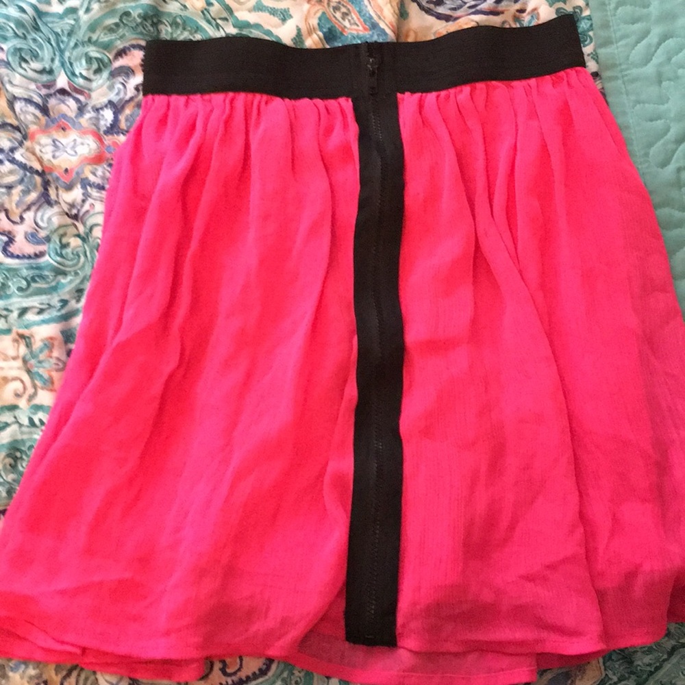 A hot pink skirt with black zipper in the front